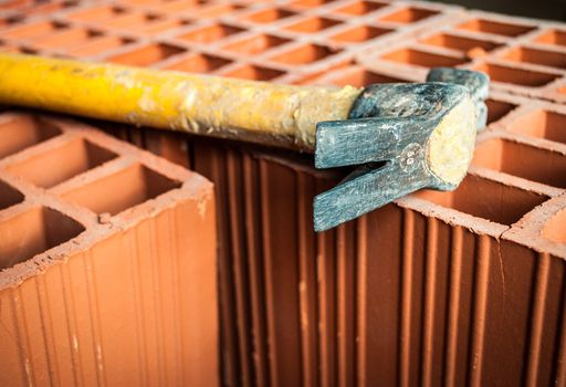 Hollow brick with an hammer on construction site