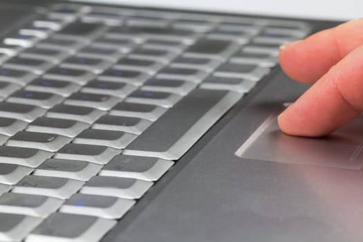 A computer operators fingers on the touchpad