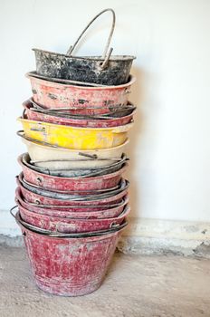 dirty masonry buckets on white wall background