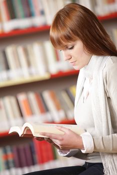 Young student reading in a library 