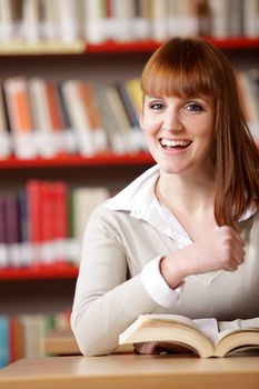 Portrait of a smiling caucasian teen girl  at library