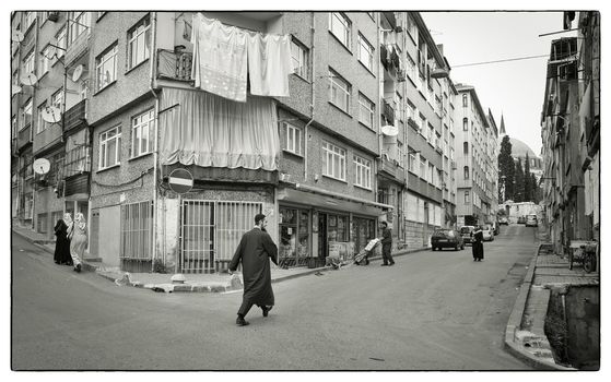 EVERYDAY IN FATIH, ISTANBUL, TURKEY, APRIL 17, 2012: A Muslim man hurry towards the Yavuz Sultan Selim Mosque, Carsamba, Istanbul, Turkey for the afternoon prayer.