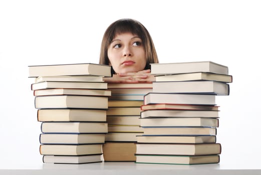 young woman behind a big pile of books 
