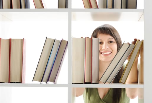 young Woman looking for a book at the library