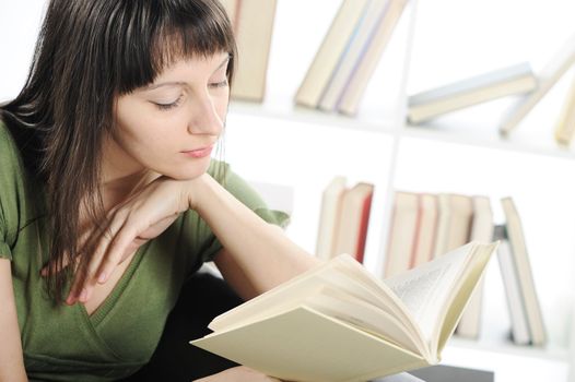 bright picture of young woman woman with book , bookshelf on background