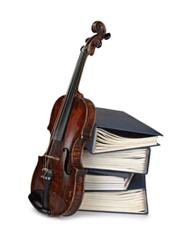 Old classical violin with  books isolated on white