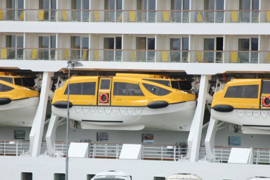 A row of safety lifeboats on a big cruise ship