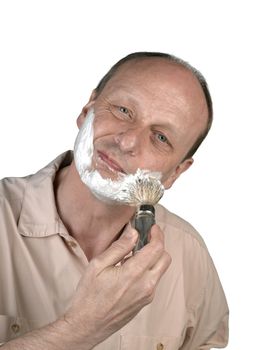 man apply shaving foam on face in bathroom