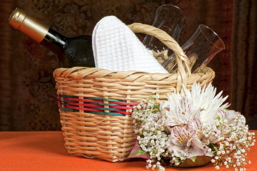 A basket with bottles and glasses Composition