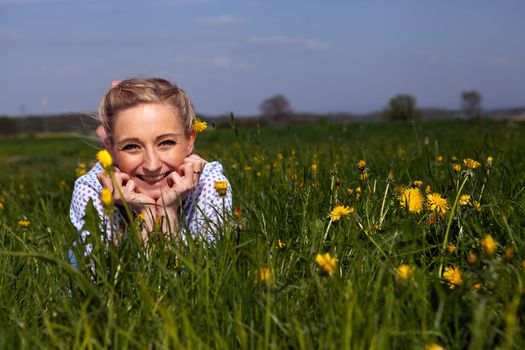 smiling woman outdoor in summer with flowers