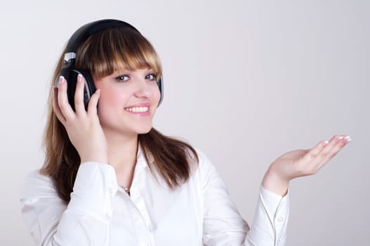 portrait of a beautiful woman in a white blouse, listening to music and happy