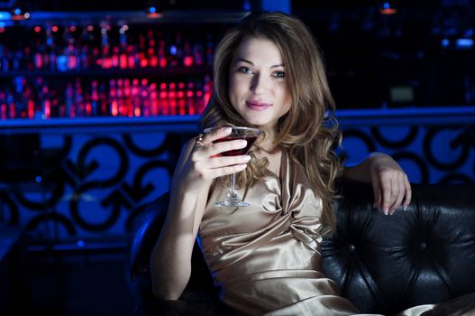 beautiful young woman, rest on Leather sofa and drinks beverage