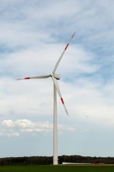 alternative energy source. wind turbine with spare rotor blade lying in front