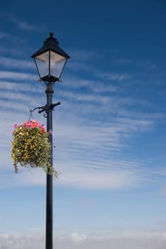 A Colourful Vintage lamp post scene wih hanging basket and Copy Space