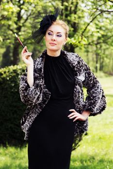 Retro-styled woman with cigarette outdoor