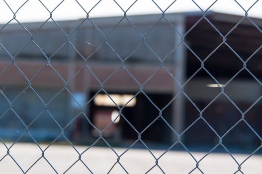 a wire mesh in front of a factory building