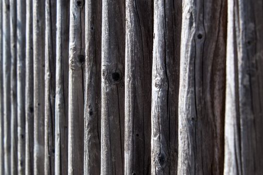 the colour and texture of a part of a weathered wooden fence.