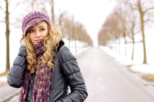 young woman outside in winter in snow cold