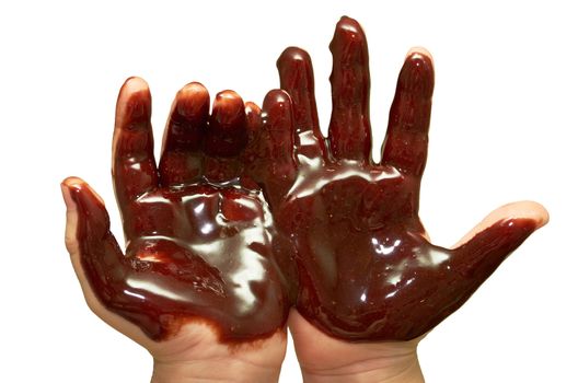 Children's hands stained with thick chocolate frosting