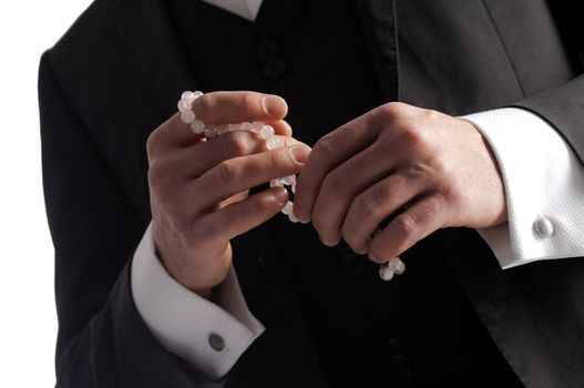 Cropped image of young male hands holding rosary
