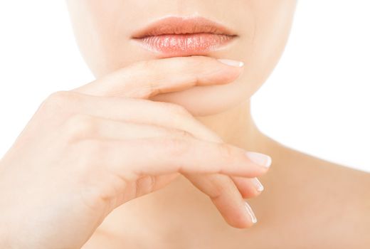 Close-up of beautiful female lips and hand on chin