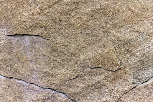 	
stone rock with cracks in the background