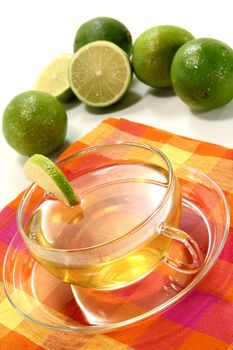 a cup of lemon tea with fresh lime