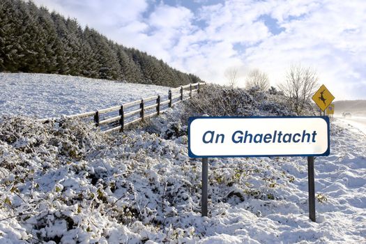 an ghaeltacht sign in snow scene in irish speaking area of county Kerry Ireland
