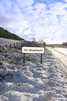 an ghaeltacht sign in snow scene in irish speaking area of county Kerry Ireland