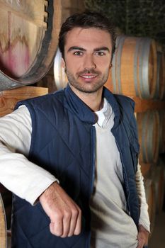 Man stood in wine cellar