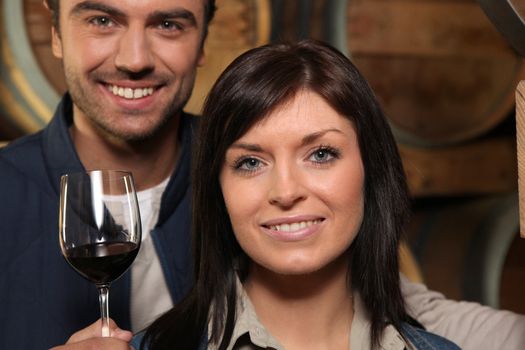 Couple drinking red wine in a cellar