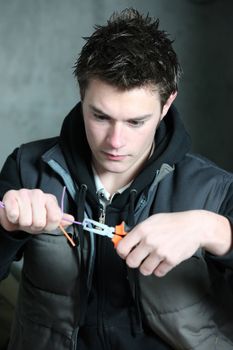 young electrician using pliers