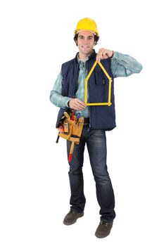 Man holding tool in shape of house