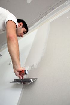 Tradesman spreading plaster