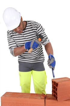 Worker using a hammer and chisel