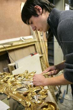 Man repairing art frame