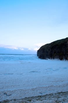 sweeping waves of foam on a dark evening during a storm of the west coast of ireland