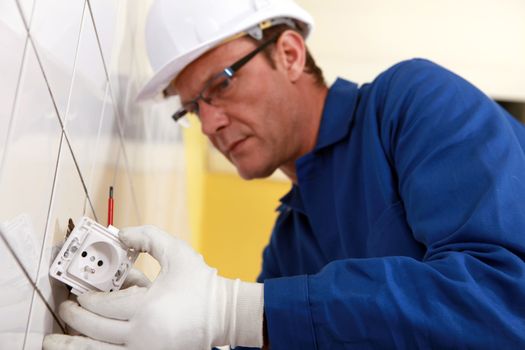 Electrical engineer fixing socket