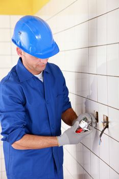 electrician connecting an electrical outlet
