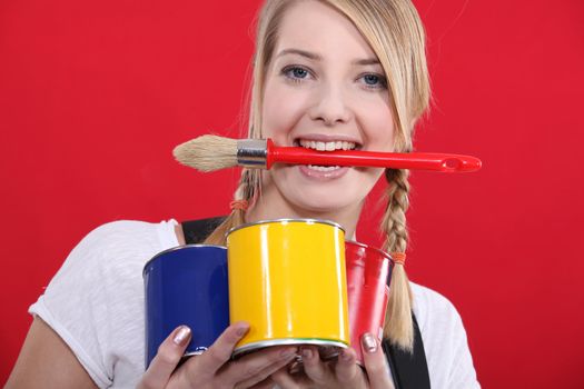 portrait of female painter holding brush between her teeth