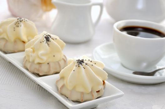 Cookies with zefirnoy filling in milk glaze with a cup of coffee