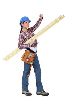 craftswoman carrying wooden boards