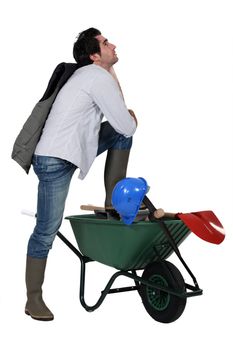 Man with wheelbarrow and spade