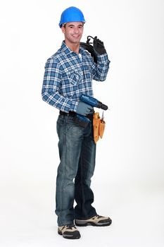 A man holding a driller.
