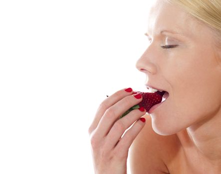 Young beautiful caucasian lady tasting yummy strawberry, closeup shot
