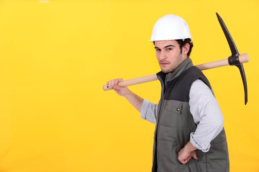 Confident worker with pick-axe