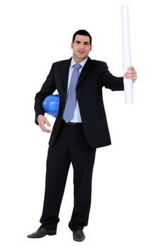 businessman holding a helmet and a blueprint