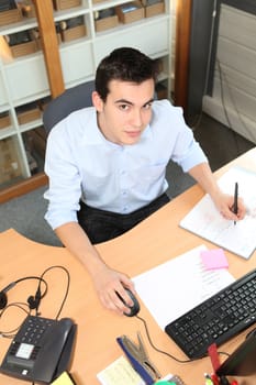 Young man working at an office desk