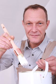 Man preparing to paint a house
