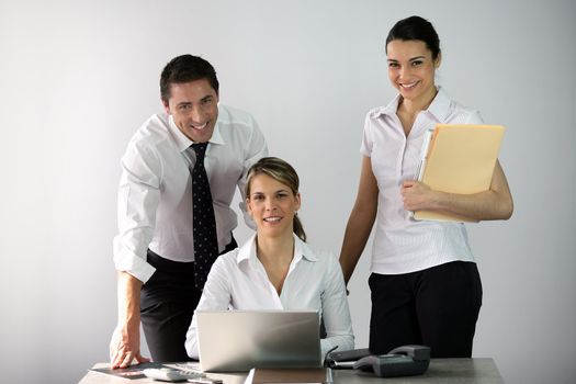 Three co-workers in office